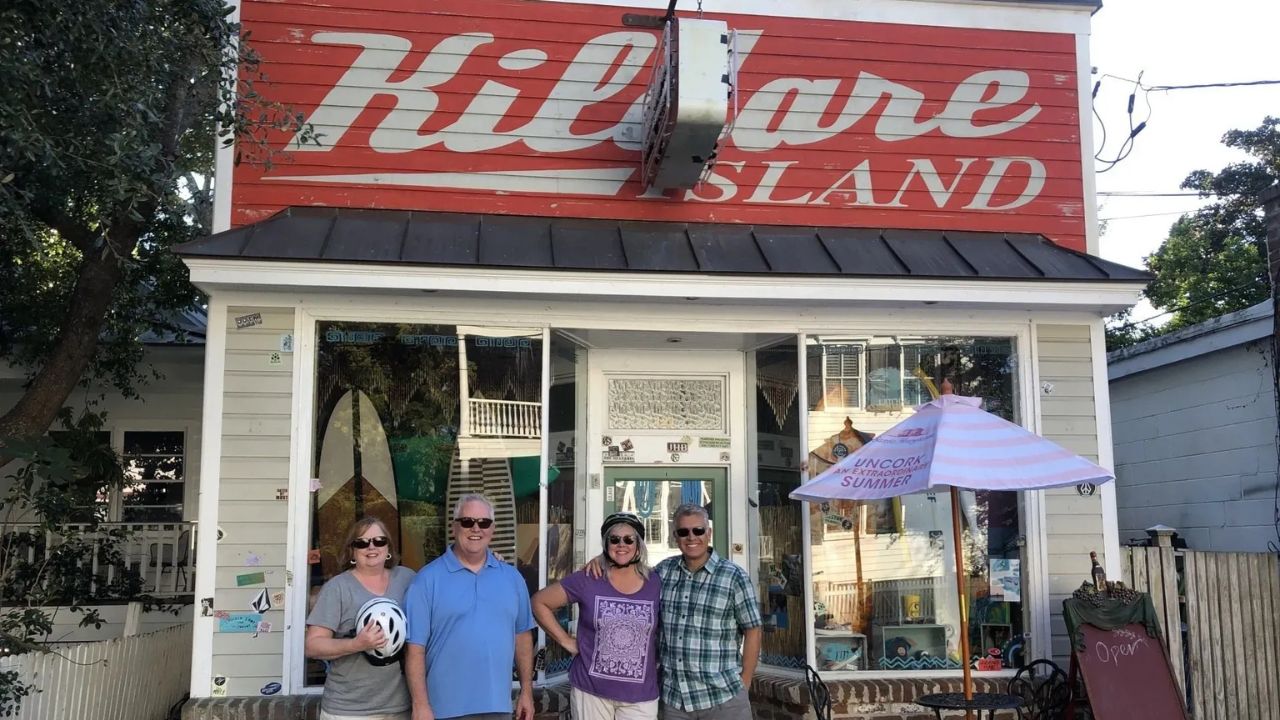 Rebellion Roads eBike Tour - Couple with Kildare County Sheriff SUV and surf shop, Outer Banks filming location